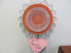 #73 Orange Flower Stake donated by Lori & Sara.